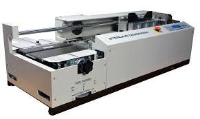 Book binding machine in action. Perfect Binding Machines Spiel Associates Inc