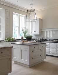 Expand your kitchen paint ideas when you plan a striking feature wall. White Kitchen Black Worktop