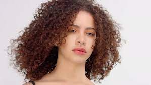 Straight hair + afro hair = curly hair. Mixed Race Black Woman With Freckles And Curly Hair Closeup Portrait With Hair Blowing By Rudovideostudio
