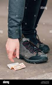 Fortunate Woman Picking Up Money Found On The Street Pavement Fifty Euros On The Ground Stock Photo Alamy