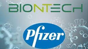 A syringe are seen in front of the pfizer logo in. Pfizer Biontech Clinch 1 95b Vaccine Deal From Us