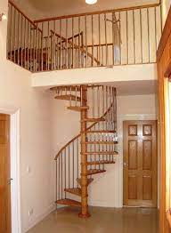 Natural Wood Interior Door Feat Simple Spiral Staircase Design And Neutral Wall Idea Spiral Staircase Plan Wooden Spiral Staircase Spiral Staircase