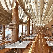 Using a monochromatic blue color palette built on a base of sandy neutrals, decorate with coastal elements. The Bouni Beach Bar Design By K Studio
