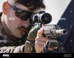 U.S. Army Sgt. Caleb Ash, senior sniper and team leader for the Kansas  National Guard's Headquarters Company, 2nd Combined Arms Battalion 137th  Infantry Regiment, 155th Armored Brigade Combat Team, prepares his weapon