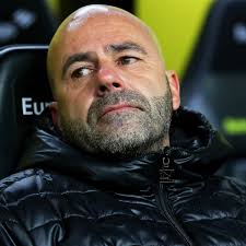Peter bosz with a picture in the background. Borussia Dortmund Sack Peter Bosz And Appoint Peter Stoger As New Manager Borussia Dortmund The Guardian