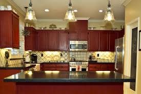 Our weekend renovation a new modern kitchen black counte… Cottage Kitchen Red Cabinets Spanish Tile Backsplash Honed Black Granite Countertops Home Remodeling Red Cabinets Black Granite Countertops