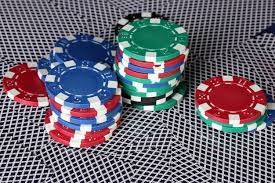 Premium Photo | Poker chips and playing cards on a red table closeup