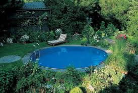 Flowers Trees And Shrubs In A Green Garden Containing A Blue Round Pool Small Backyard Pool Ideas Striped In 2020 Small Backyard Pools Garden Pool Design Pool Designs