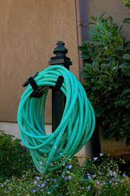 10 Most Inspirational Hose Caddy Design Ideas For Your Garden Home And Apartment Ideas Hose Holder Garden Hose Holder Garden Hose Storage