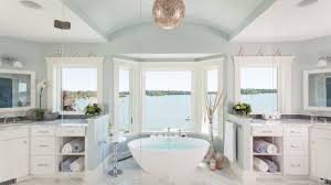 A lovely beach bathroom with mint green touches, fish scale tiles in the shower and a mint floating vanity and brass touches decor bring a coastal feel to your bathroom with gorgeous tiles in a chosen color: 17 Beautiful Coastal Bathroom Designs Your Home Might Need