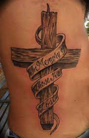 Cross tattoo with skull design in it and looking very beautiful on thigh of a women. 60 Incredible Cross Tattoo Designs