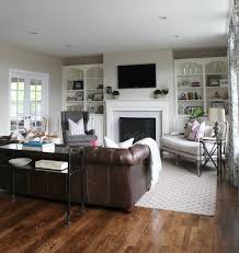 See more ideas about living room decor, brown living room, home decor. Dark Couch Grey Walls White Shelving Family Friendly Living Room Home Living Room Living Room With Fireplace