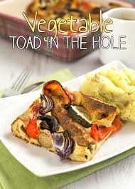 Toad in the hole or sausage toad is a traditional english dish consisting of sausages in yorkshire pudding batter, usually served with onion gravy and vegetables. Vegetable Toad In The Hole Vegetarian Sausages And Roasted Veggies All Cooked In A Yorkshire Pudding Batter A Clas Veggie Recipes Healthy British Food Food