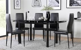 Each chair has a sturdy metal frame and a comfy padded seat and backrest. Space Black Glass Extending Dining Table With 4 Leon Black Chairs Black Leg Black Dining Room Black Dining Room Table Dining Table Black