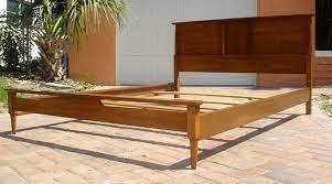 It is finished in a walnut veneer on the headboard and the legs are a solid walnut. Full Size Vintage Mid Century Modern Bed