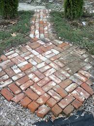A reverse bond set in a circular pattern gives visual interest to a small patio area in a lush garden. Pin By Jen Hunt On My Own Garden Pins Small Brick Patio Brick Patios Patio Images