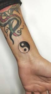 This style of yin yang tattoo looks amazing especially with the inclusion of the tribal patterns making it more interesting to look at. Yin Yang Tattoos