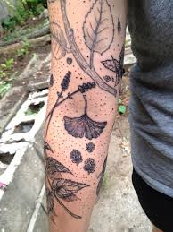 Black flower and triangle tattoo. Leaves Tattoo