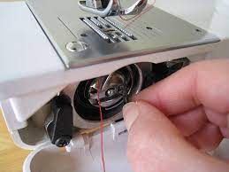 Look for a button or tab on the bobbin case. How To Thread A Bobbin On A Sewing Machine Sewing From Home