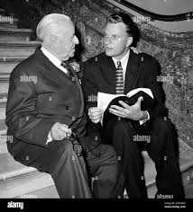 Evangelist Billy Graham, right, visiting in the Capitol, in Washington,  March 6, 1958, reads the Holy Bible with Rep. Frank W. Boykin, -Ala. The  two were seated