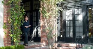 Black paint highlights window sashes and dentil moldings running across window and door trim. Desire To Decorate The Red Brick House Brick Exterior House Red Brick House Exterior Brick