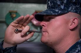 Boatswains's Mate 3rd Class Dallis Collins stands