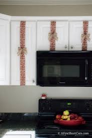 Wreaths on the back of kitchen bar chairs. Christmas Cabinet Ribbon Decorations A Few Shortcuts