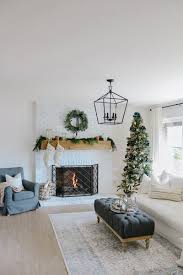 The black candles paired with a green base; Modern Farmhouse Christmas Living Room With Navy Copper Rose Gold 1111 Light Lane