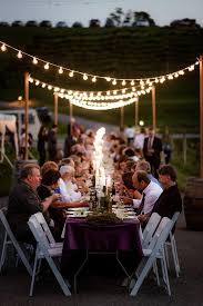 Outdoor Cafe Lighting Draped Over A 200 Long Dinner Table Lighting Support Poles Are Made Out Of Whiskey B Outdoor Wedding Lighting Party Rentals Party Tent