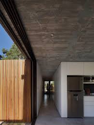 Similar Panels Form The Main Entrance To The Residence On The Opposite Side While The Remainder Of The Wall Concrete Houses Concrete House Concrete Interiors