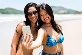 Located in front of enseada beach, it's really nice place with clean room and amazing staff! Brasil Sao Paulo Ubatuba Two Happy Young Women Taking A Selfie On The Beach Vabf01092 Valentina Barreto Westend61