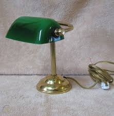 The banker's desk lamp with green glass shade, brass finish features a durable metal design with a shiny brass finish, a small round base, and a rectangular green glass shade that makes it perfect for use in any home office or professional workspace. Vtg Mini Bankers Lamp Green Glass Shade Desk Table Top Taiwan 415356415