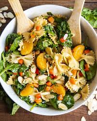 Asian Pasta Salad With Spinach Mandarin Oranges Red Peppers And Sliced Almonds Tossed In A Bowl With In 2020 Pasta Salad With Spinach Pasta Salad Asian Pasta Salads