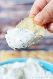 Someone Holding A Potato Chip With Chip Dip On It Chip Dip Recipes Best Chip Dip Cold Dip Recipes