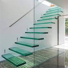 Clear glass panels highlight a beautiful staircase and a modern aesthetic. China Interior Modern Floating Staircase Tempered Glass Stair With Glass Railing Design China Glass Stairs Modern Staircase