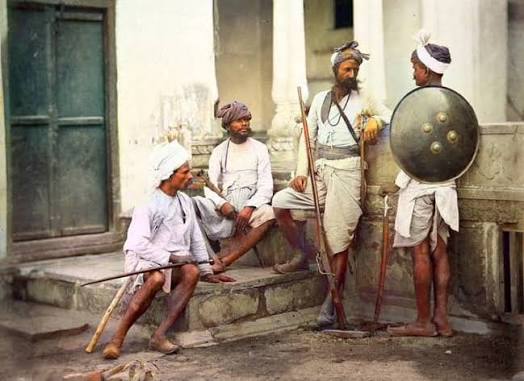 This vintage photograph captures Chauhan Rajput warriors in Delhi, India, taken around the early 1860s. This famous image is titled "Chohan Rajpoots, Delhi". It was taken by the prominent photography firm Shepherd