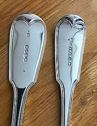 This flatware is made of a blend of silver and base metals is solid, not plated, but has a much lower silver content than either sterling or coin. Silver Hallmarks Wikipedia