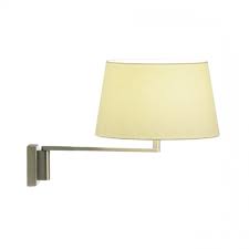Adrastée lamp is a very graphical table lamp of astral inspiration, the light creates a soft and nice halo around the main circle, light diffusion is rotating due to the lampshade. Santa Cole Americana Wall Lamp Ambientedirect