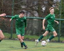 students in a sports club playing football resmi
