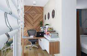 This small home office features a modern wood desk that's easily tucked into one corner of the room. 21 Modern Ideas To Brighten Up Small Office Designs