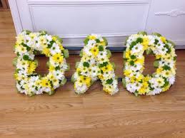 For funeral flowers for dad at the funeral home, these standing sprays are created with freshly cut florals in strong colors and contrasting clean styles that are perfect for masculine these designs are some of the most popular casket spray deliveries for male family members and departed male friends. Yellow White And Green Dad Letters Funeral Flowers Funeral Tributes Flowers