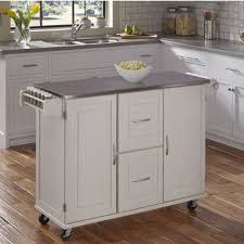 Add style to your home: Patriot Mobile Stainless Steel Kitchen Cart With Two Adjustable Shelves In Each Cabinet Door Two Deep Storage Drawers Towel Bar And Spice Rack In Black Or White Finish By Dolly Madison From