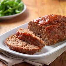 Slices of meatloaf with creamy mashed potato and steamed . Classic Beef Meatloaf