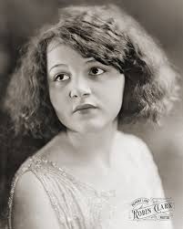 This W. J. Ramsey portrait shows a young woman in a beaded dress. Taken by  photographer W. J. Ramsey in Gainesville, Georgia, around the 1920s.