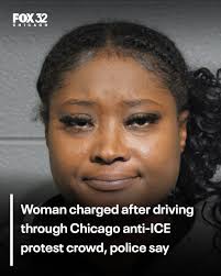 A woman was arrested for allegedly driving her car through a crowd during  anti-ICE protests in downtown Chicago earlier this month.