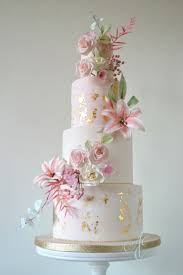 Wedding Cake Iced In Ivory And Pale Blush With Distressed 24 Carat Gold Leaf And A Profusion Of Romantic Wedding Cake Ivory Wedding Cake Elegant Wedding Cakes