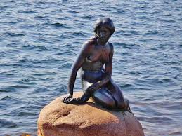 The little mermaid is a bronze statue by edvard eriksen, depicting a mermaid becoming human. The Little Mermaid Statue Copenhagen Denmark Beyond The Lamp Post Literary Travel World Literature
