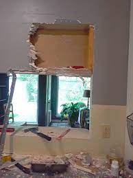 Pull the layout measurements off of an existing wall stud and mark the locations on the bottom plate. Enlarge Opening In Load Bearing Wall