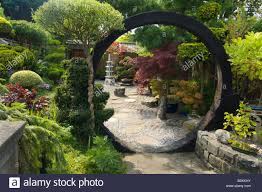 Stock Photo Japanese Style Garden With Moon Gate Rocks Shrubs And Trees Design By George Japanese Garden Backyard Japanese Garden Landscape Zen Garden Design