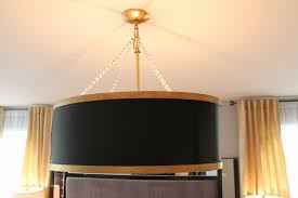 I had a couple of those taking up space in my storage room. Make Your Own Drum Shade Chandelier Diy Tutorial Houzewize